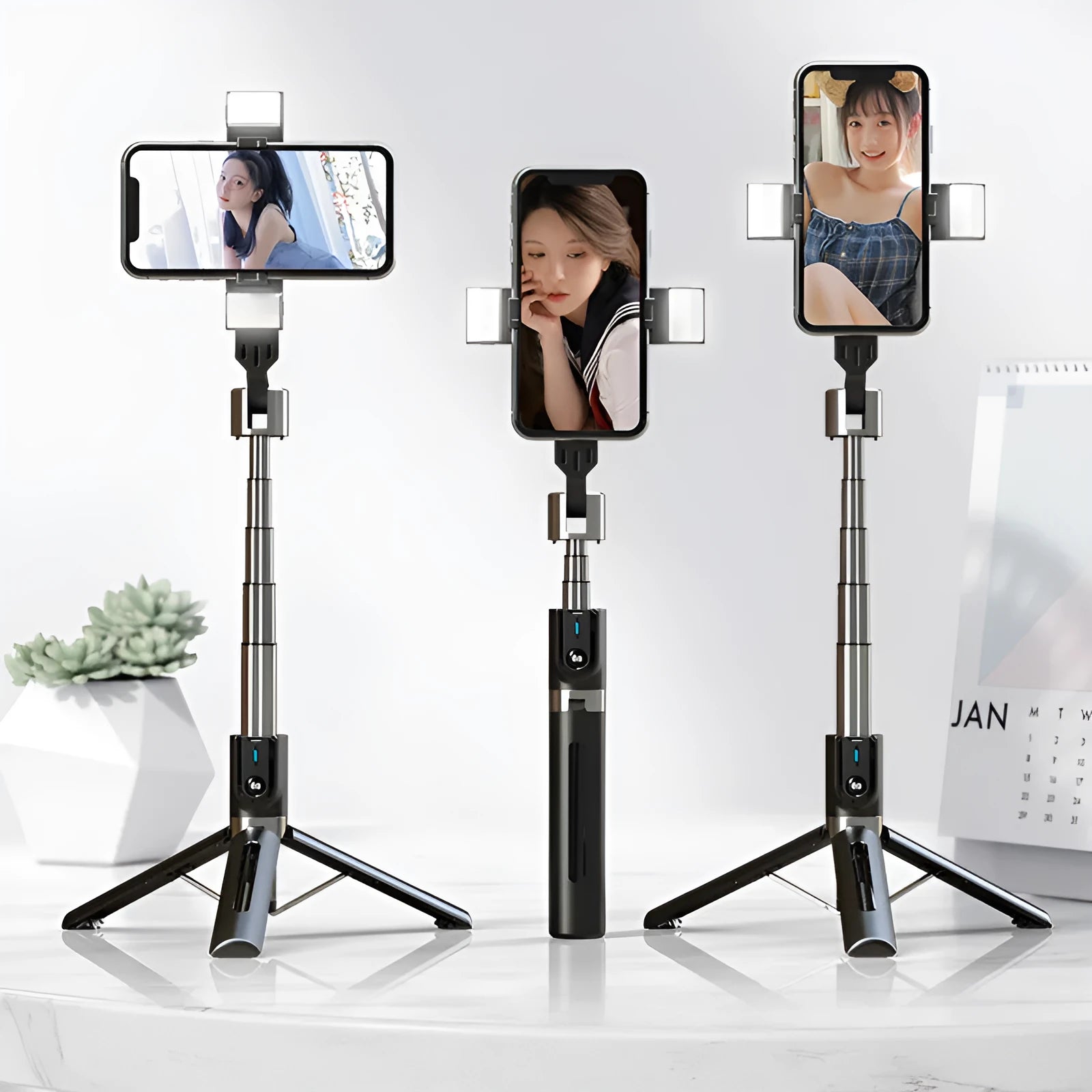 Black aluminium Bluetooth selfie stick with dual fill lights extended on a desktop.
