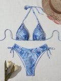 Denim blue printed women's bikini set with strap design on a mannequin, showing top and bottom.