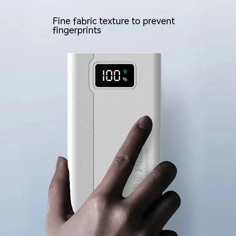 Large capacity black and white power bank with fast charging support showing size scale.
