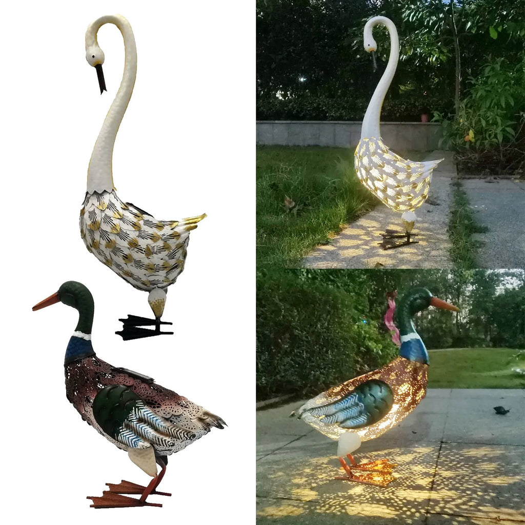 Wrought iron swan solar garden light with warm white LED on a lawn