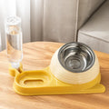 Raised cat feeder bowl with attached water bottle dispenser in green colour