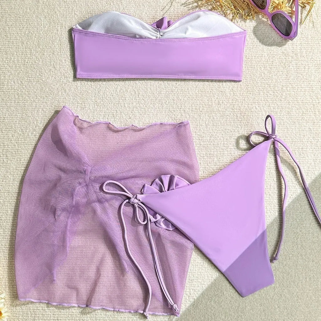 Women's pink tube top swimsuit with large 3D flower tie and matching skirt.