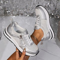 Gold women's flat lace-up pumps with round toe and rubber sole on a white background.