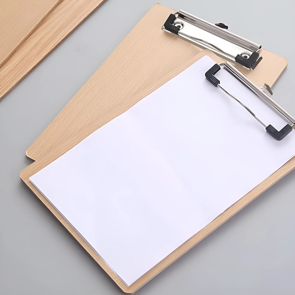 A4 wooden clipboard with metal clip and hanging hole placed on a desk