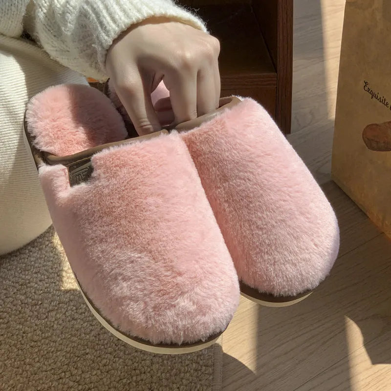 Blue plush PVC winter slipper with non-slip sole and car stitching detail on a wooden floor.