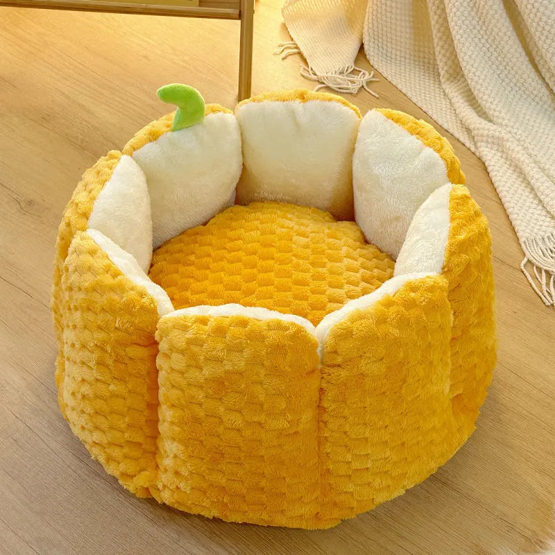 Pumpkin-shaped pet nest with raised sides and cotton filling for cats and small dogs