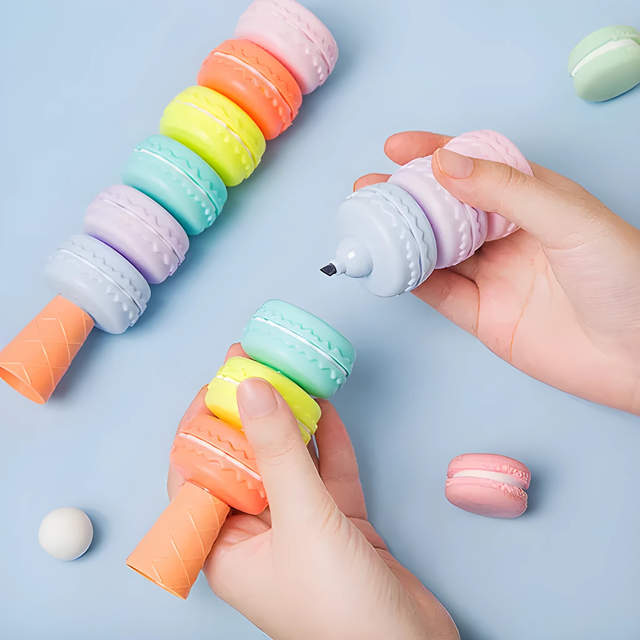 Set of six colourful cookie-shaped highlighter pens with macaron colours arranged on a white surface.