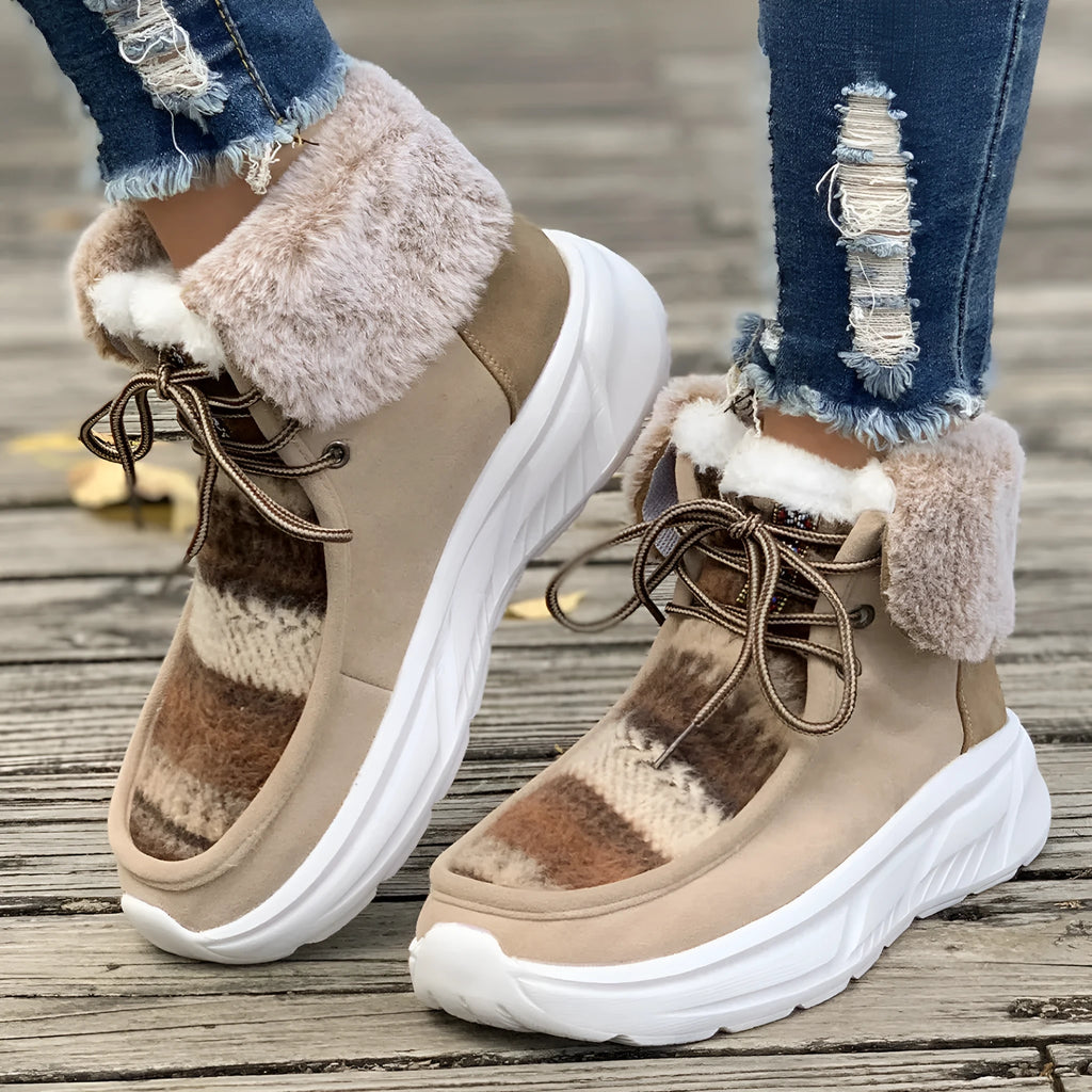 Beige women's lace-up suede snow boots with a fuzzy lining and thick rubber sole.