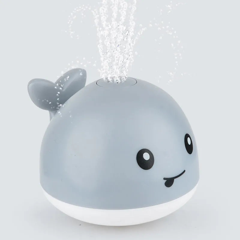 Automatic water spray whale bath toy with LED lights for baby sensory play