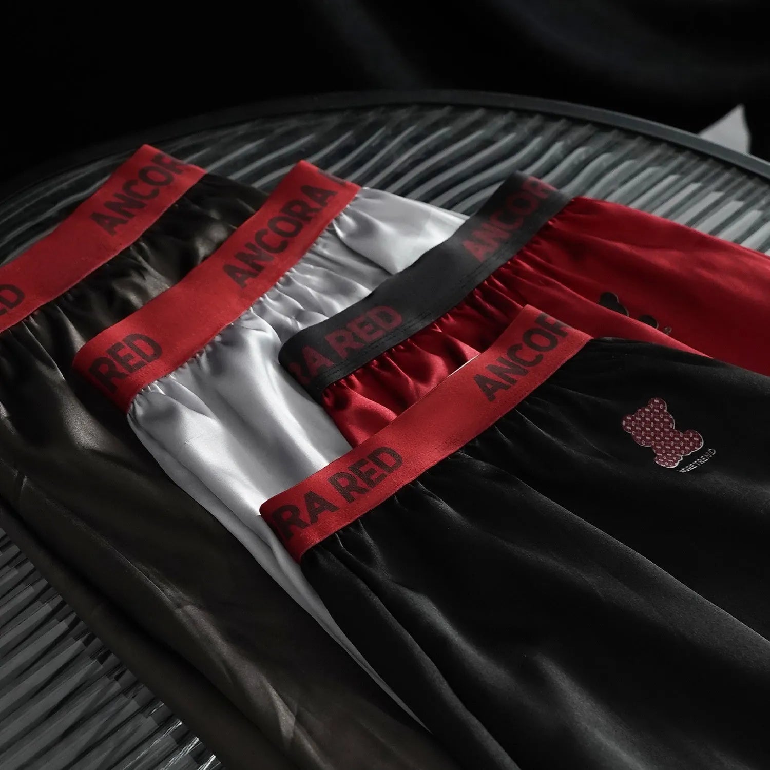 Men's solid colour polyester boxer briefs on a mid waist, shown in multiple colour options.