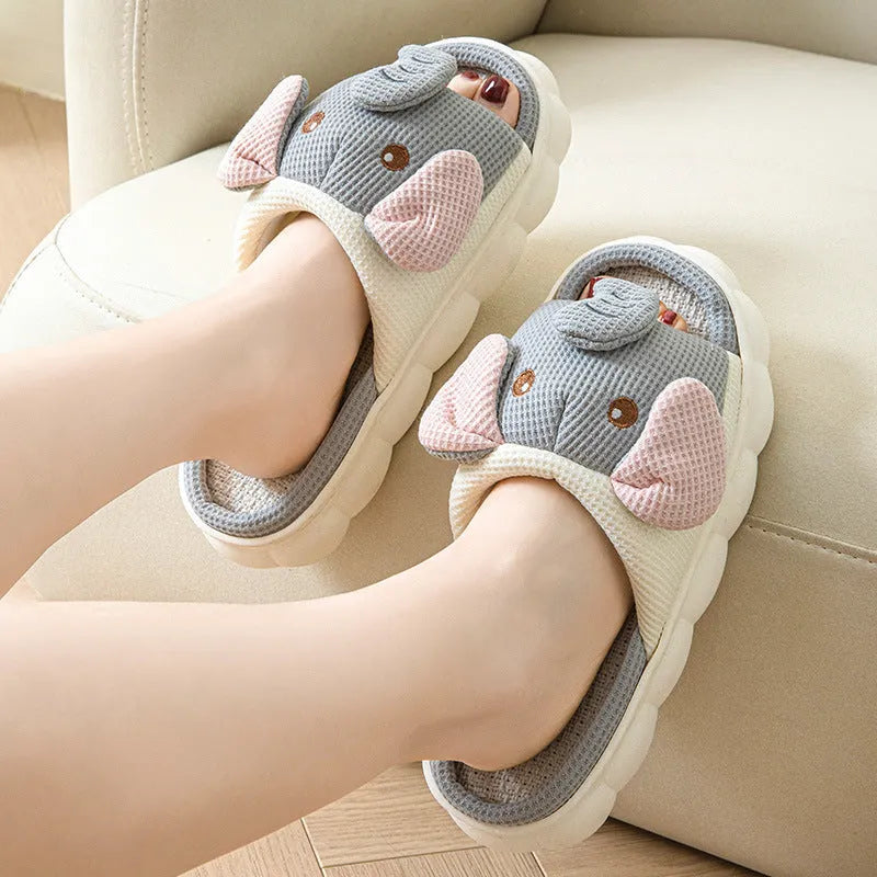 Elephant grey open-toe linen slippers for couples on a plain background, showing sewn sole detail.