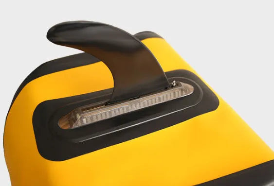SUP paddle with a removable fish fin attached via a screw mechanism.