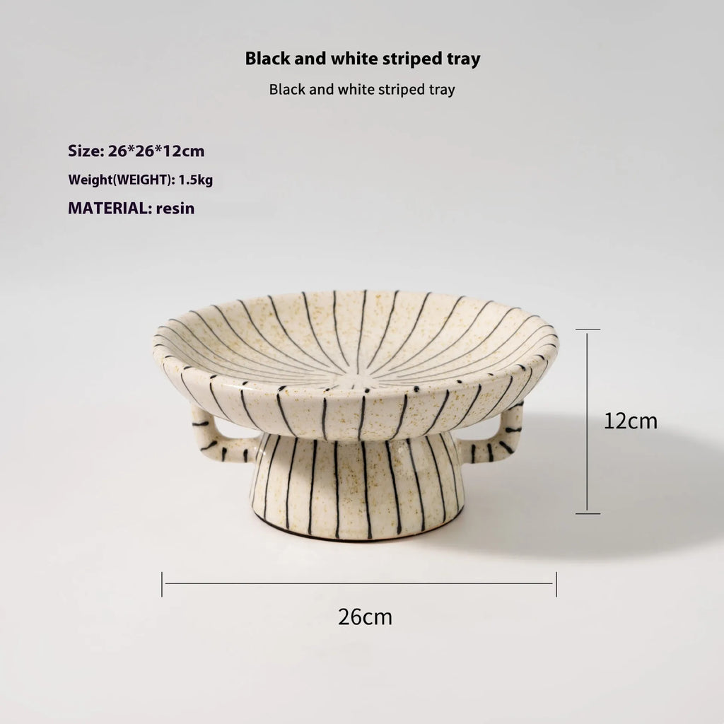 Black and white striped retro style synthetic resin fruit plate on a wooden surface.