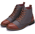 Men's black leather motorcycle-style ankle boots with belt buckle detail on the side.