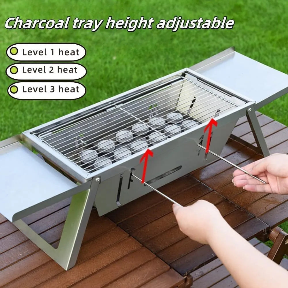 Small foldable metal charcoal grill with a carrying handle, shown in a compact stored position.