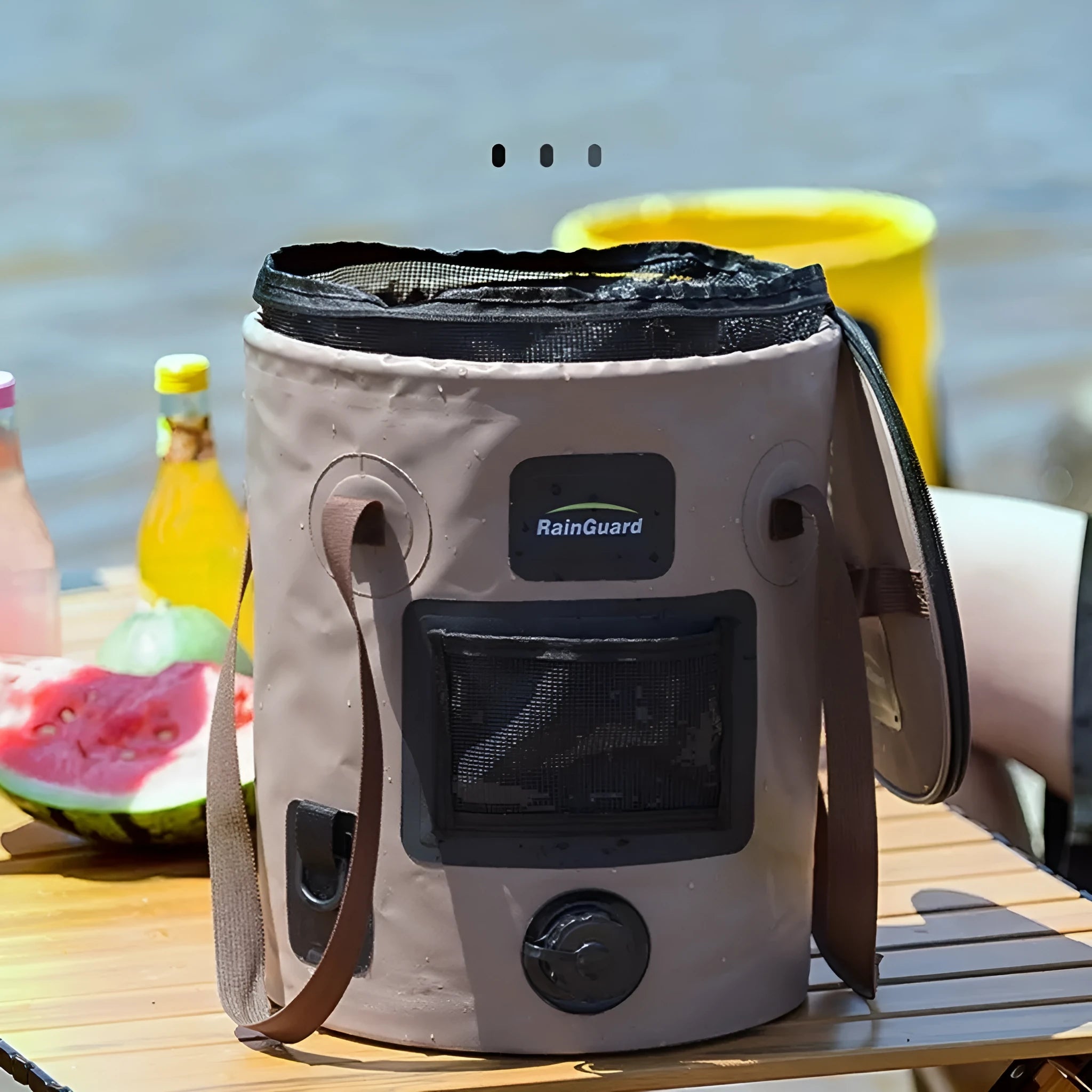 Lemon yellow plastic folding fishing bucket with a built-in mesh net pocket, shown collapsed and fully expanded.