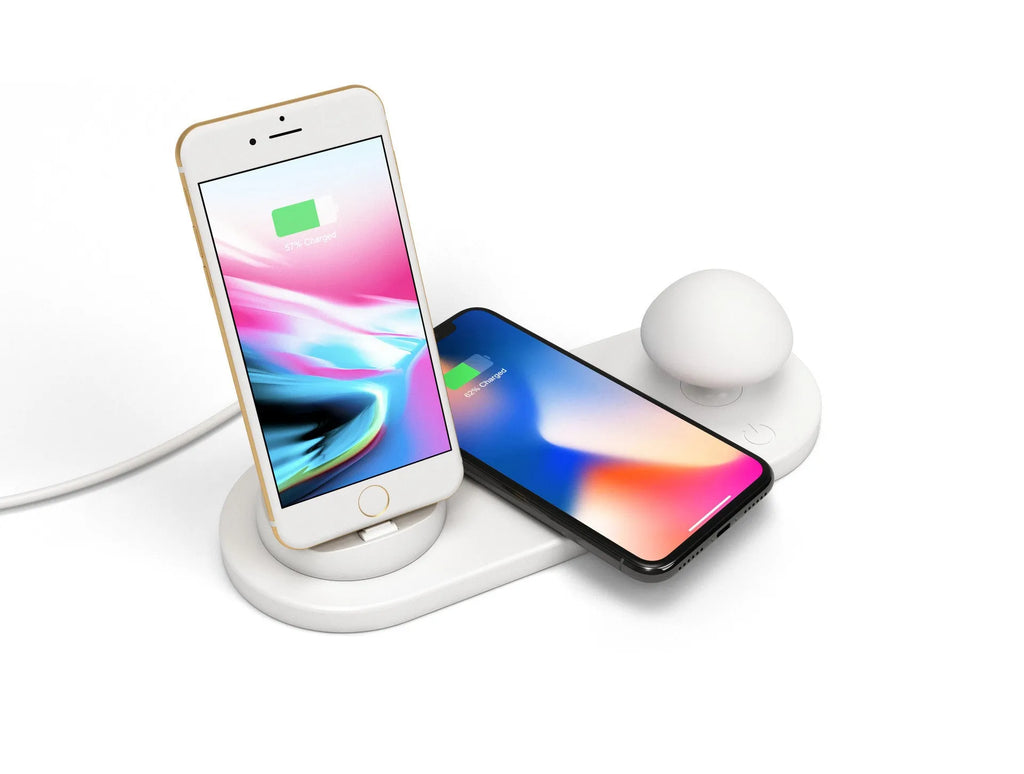 White 3 in 1 wireless charging dock with a phone on the pad and USB cable