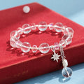 Women's white crystal bracelet with diamond shapes and lucky cat charm on wrist