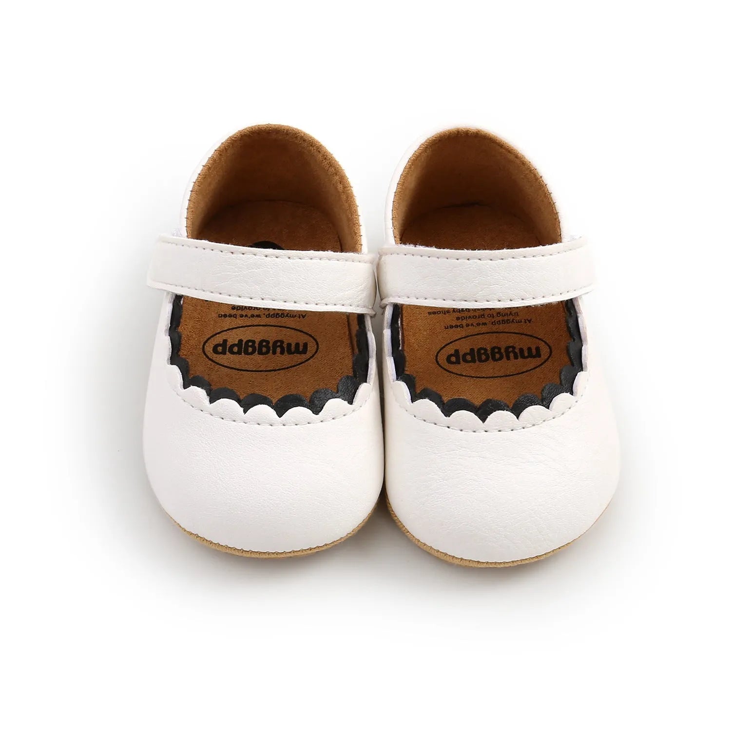 Baby girl's white velcro fastening shoes with low tube height, shown on a size chart.