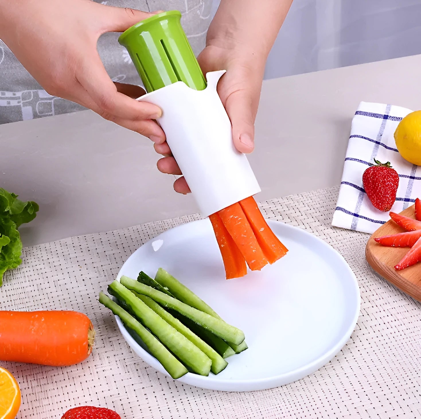 White plastic vegetable and fruit slicer with multiple stainless steel blades for cutting cucumbers, carrots, and strawberries.