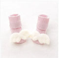 Cotton baby floor socks in a pink bow pattern, shown on an infant's feet.