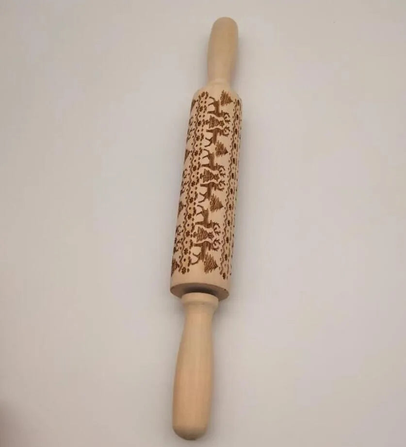 Wooden rolling pin with embossed Christmas patterns including reindeer and snowflakes on a 45cm length.
