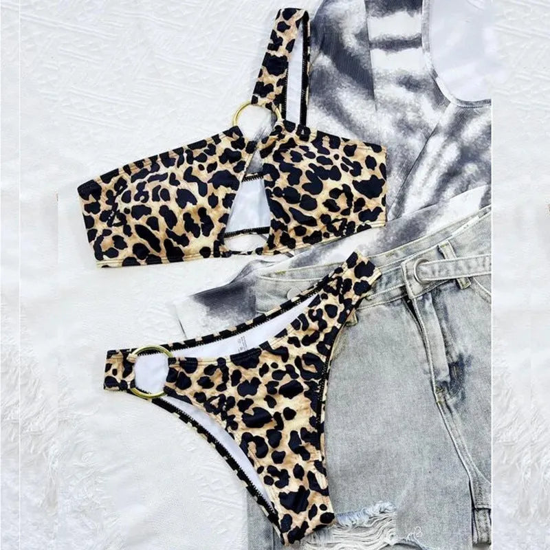 Women's leopard print and polka dot bikini set with top and shorts on a mannequin.