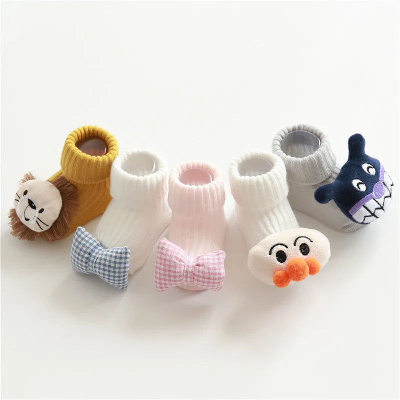Cotton baby floor socks in a pink bow pattern, shown on an infant's feet.