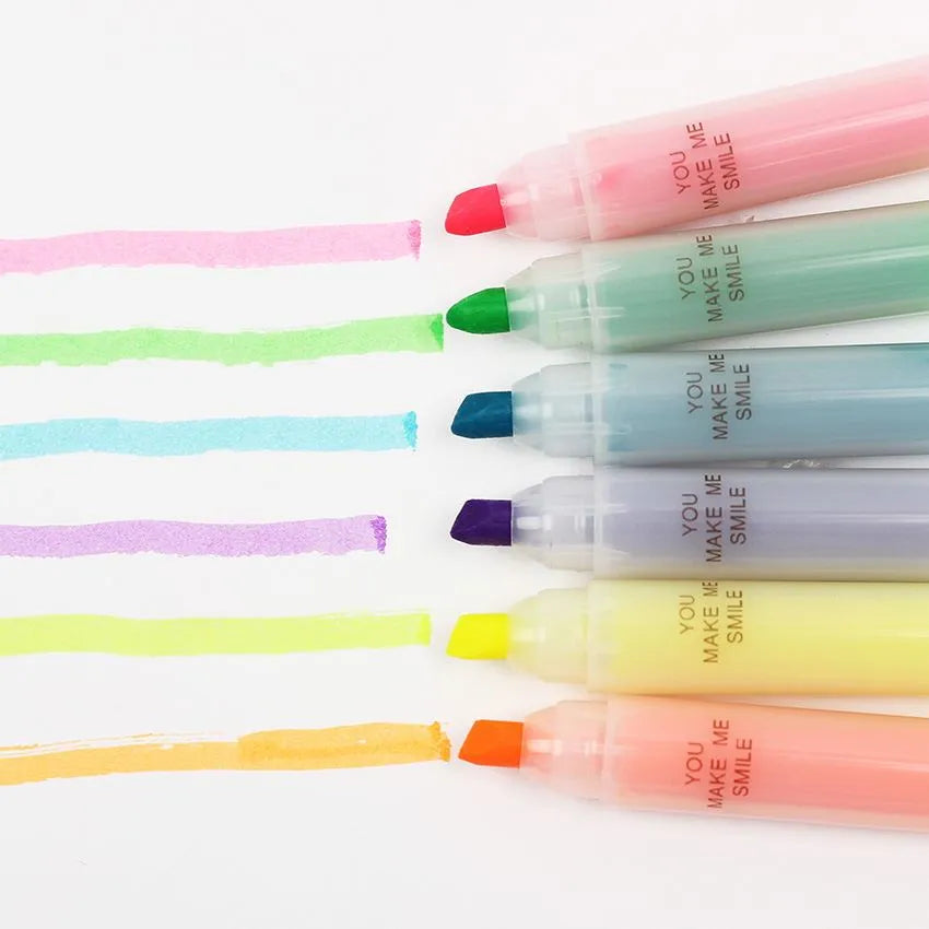 Set of six plastic highlighter pens in different colours with oblique pen shapes