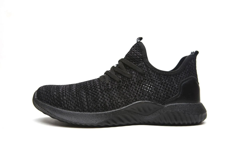 Low-cut black safety shoe with a steel toe cap on a grey background.