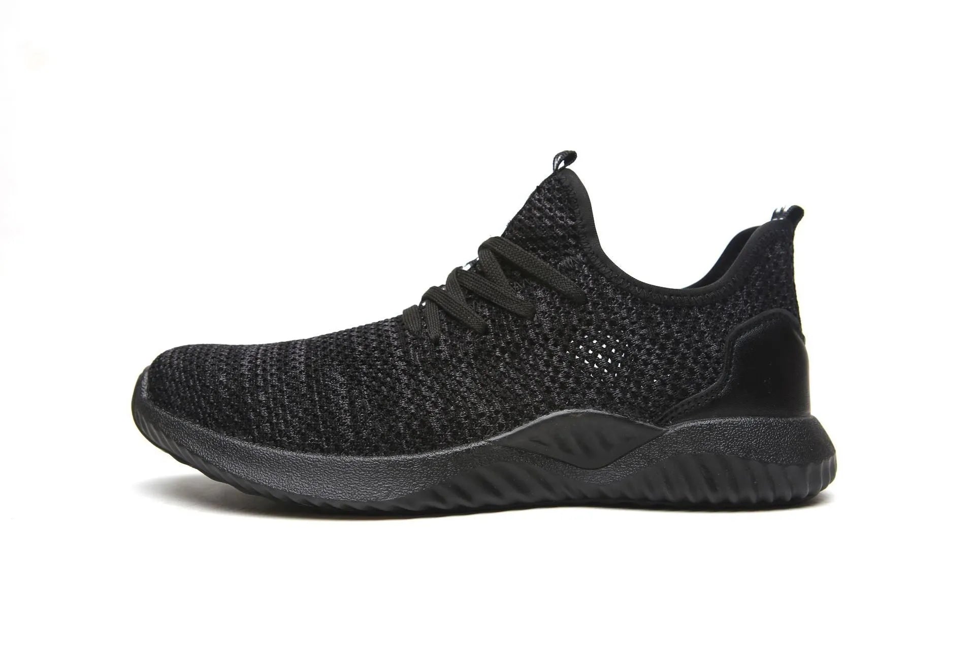 Low-cut black safety shoe with a steel toe cap on a grey background.