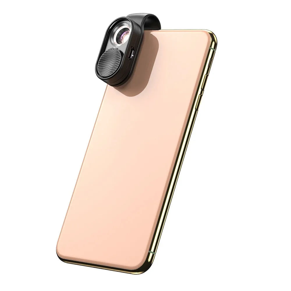 Black mobile magnification microscope with LED light clamped onto a smartphone showing 100x close-up view