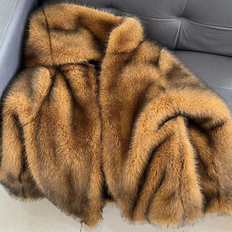 Women's loose-fitting silver grey artificial fur mid-length coat on a hanger.