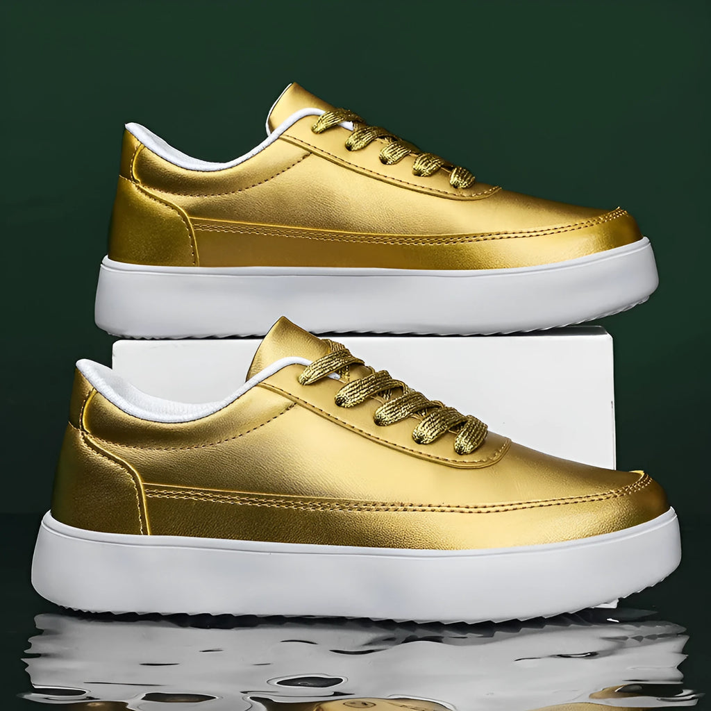 Women's gold leather lace-up flat casual shoes on a white background.