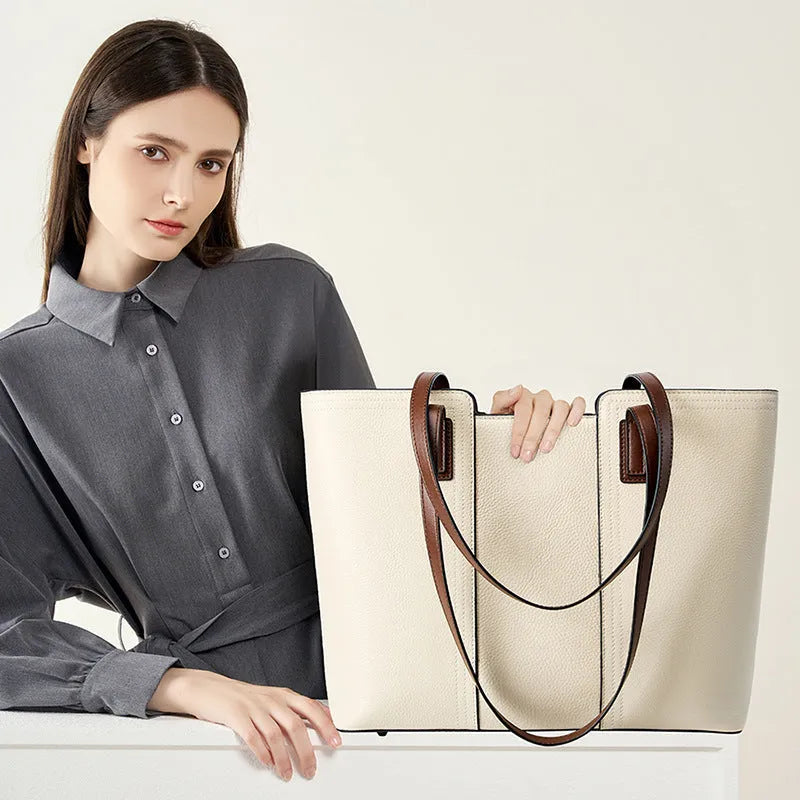 Women's black genuine leather crossbody bag showing horizontal square shape and internal organiser pockets