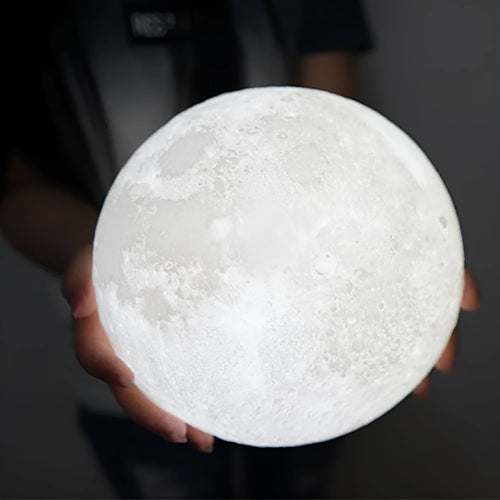 3D printed spherical moon lamp showing lunar surface texture on wooden holder