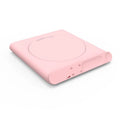 Pink and white USB heating cup pad or mug warmer with mechanical controls on a desk.