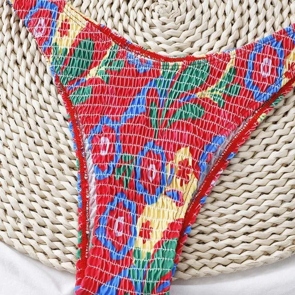 Red floral patterned women's underwire triangle bikini top and briefs set on a white background.