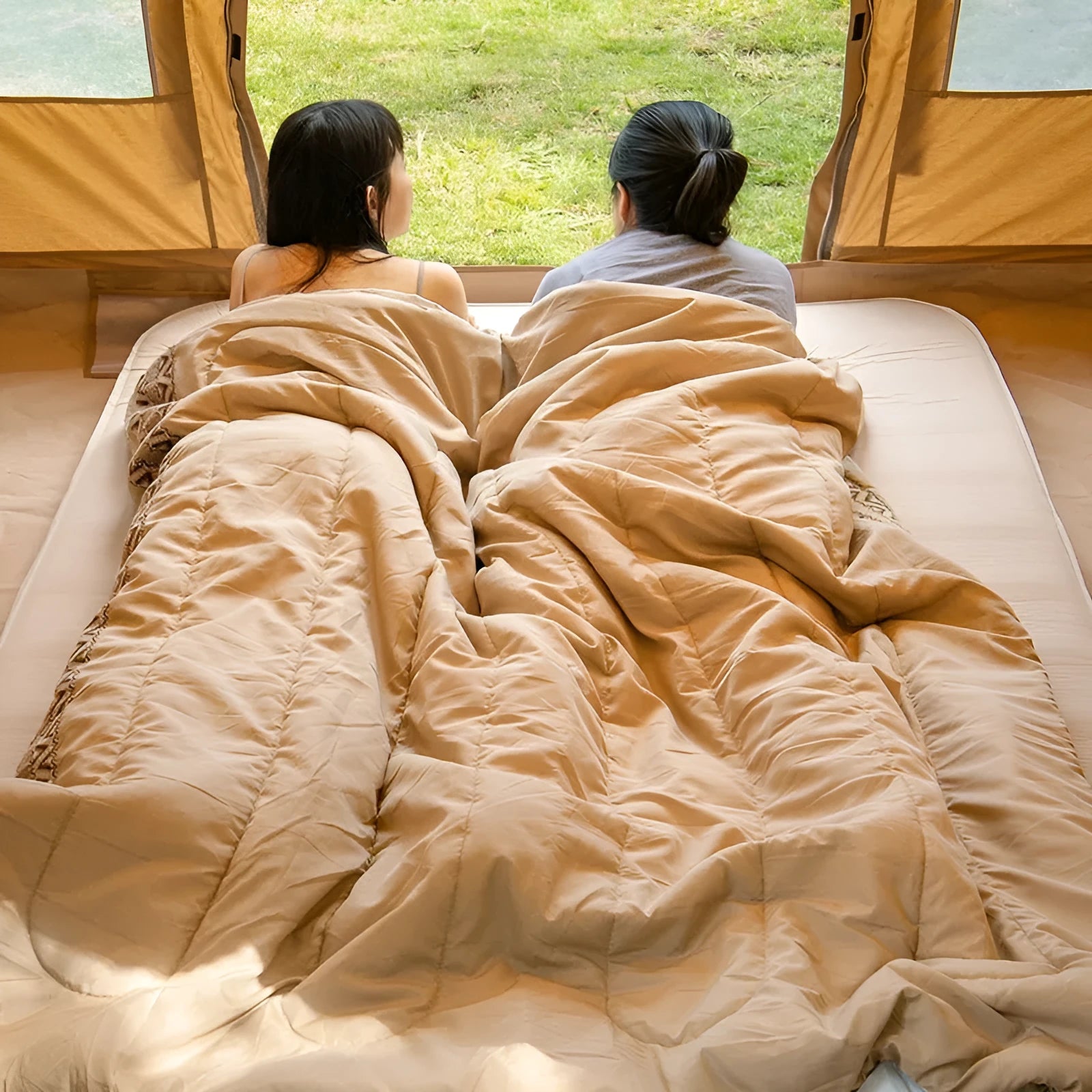 Portable outdoor sleeping bag in one of three colours, shown with its storage bag.