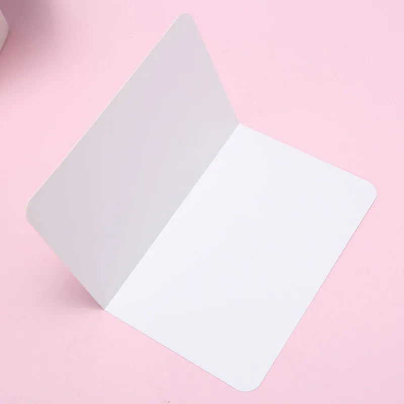 Pack of 100 plain kraft folded greeting cards in black, brown, and white, sized 10 by 15 cm.