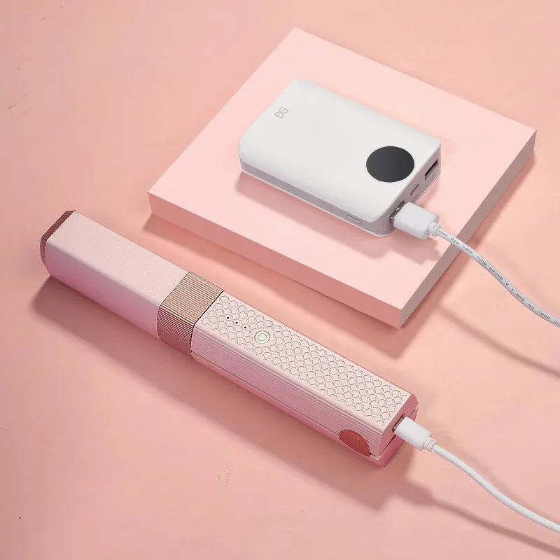 Pink and green cordless USB hair straightener and curling iron with ceramic plates.