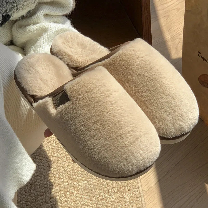 Blue plush PVC winter slipper with non-slip sole and car stitching detail on a wooden floor.