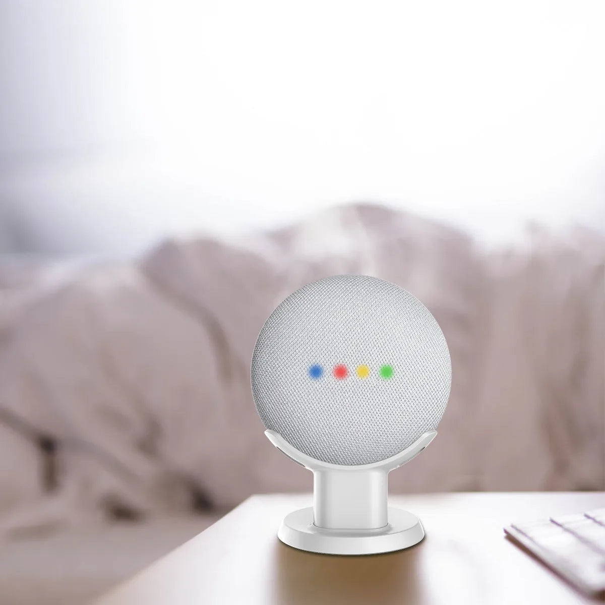 Black PlusAcc plastic stand holding a Google Home Mini speaker on a table.