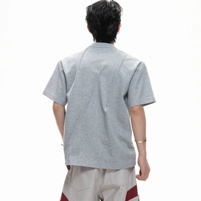 Men's black cotton T-shirt with three-dimensional pleats on the front, showing a round neck and short sleeves.