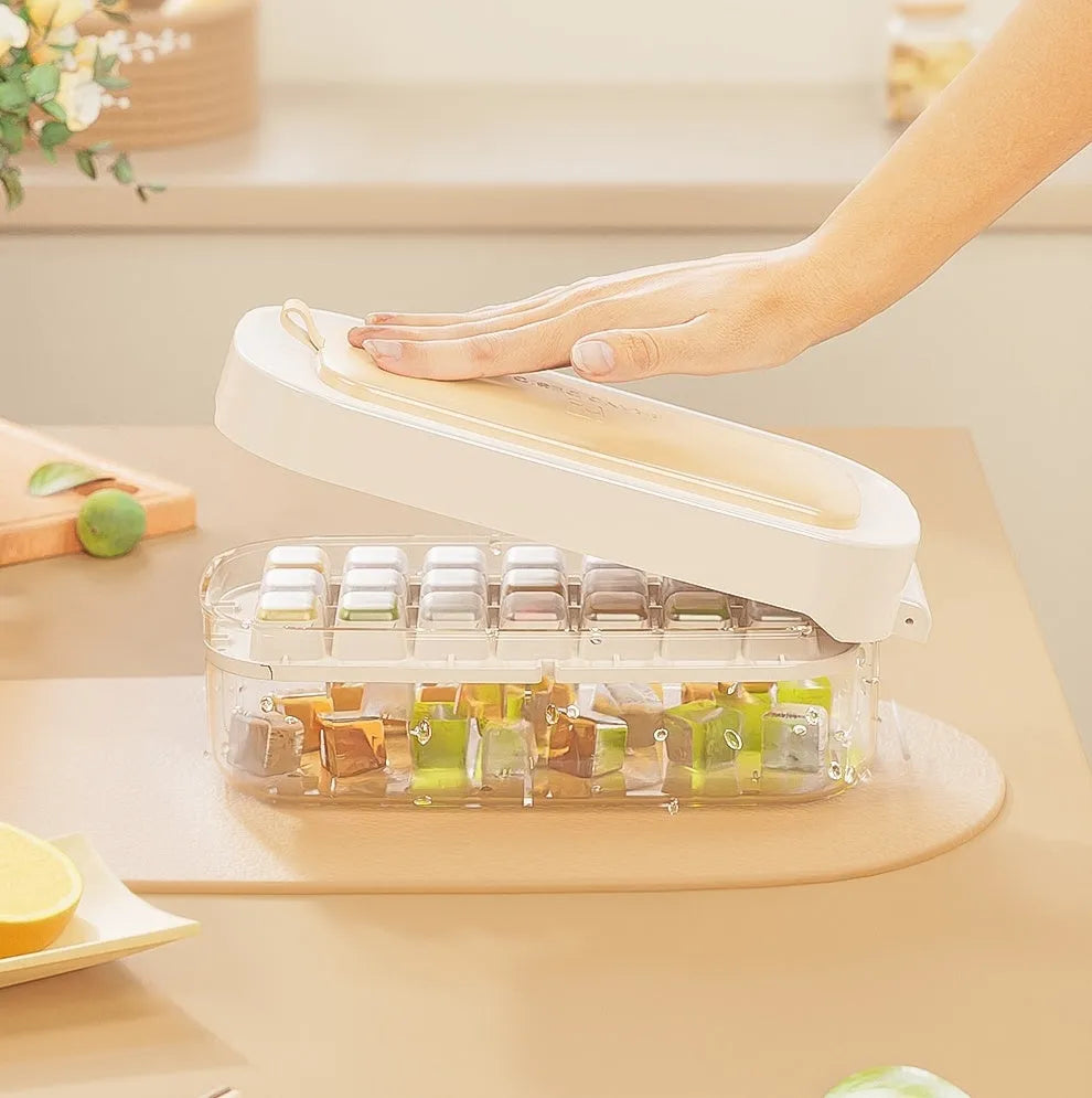 Blue high-capacity ice cube tray with grid design and an ice shovel stored on the side.