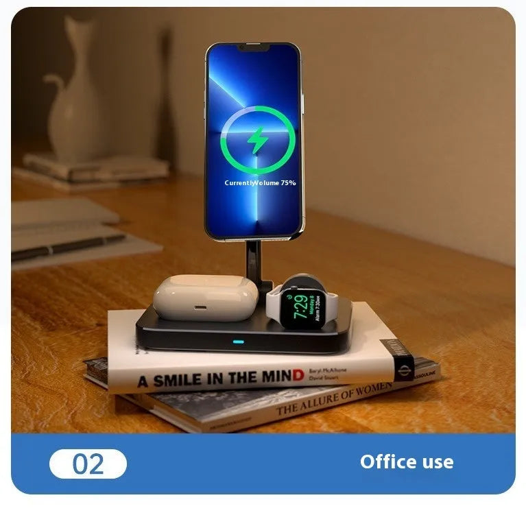 Black magnetic three-in-one wireless charger and cooling bracket on a desk, with phone upright and watch on base.