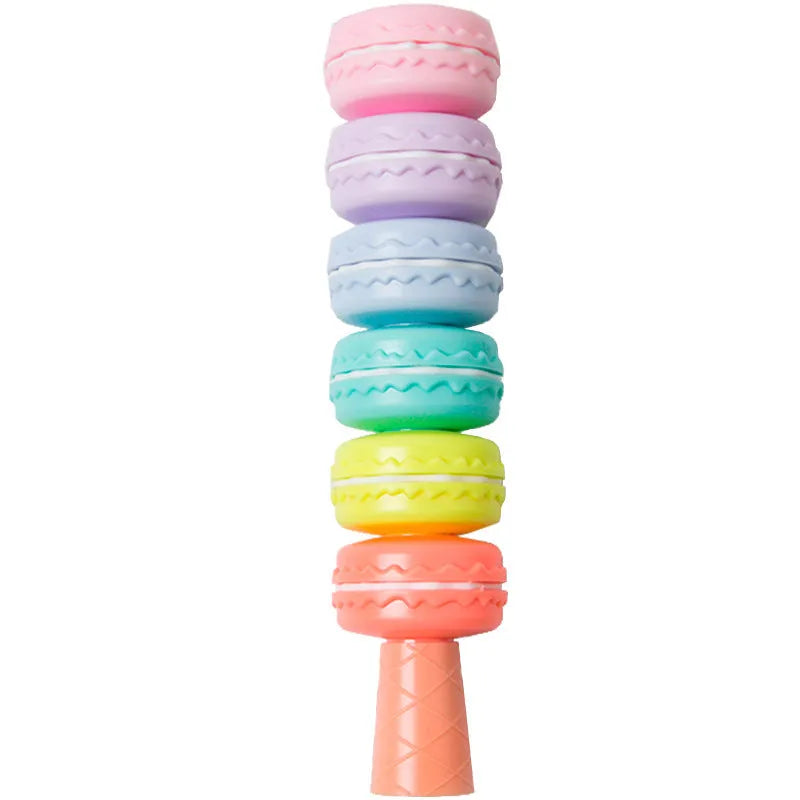Set of six colourful cookie-shaped highlighter pens with macaron colours arranged on a white surface.