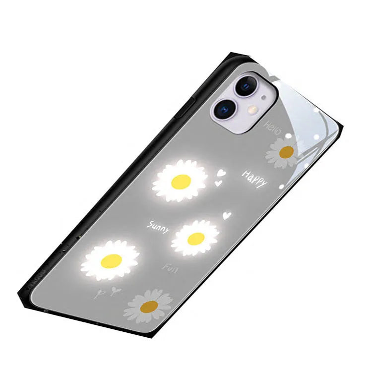 White iPhone case with painted purple daisies and voice-activated colour lights on the back.