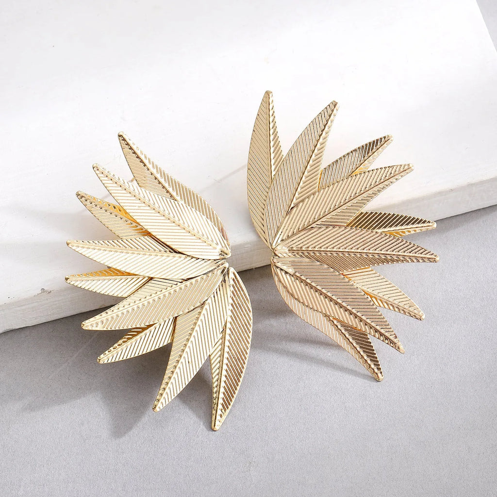 Gold and white leaf-shaped alloy patch earrings with botanical design details