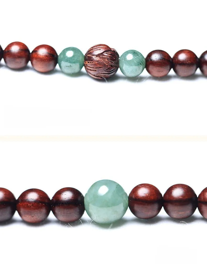 Rosewood beaded bracelet with carved wood elements and green Hotian jade pendant on wrist